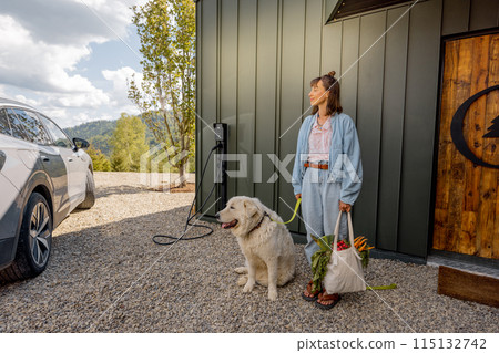 Woman going home with fresh food in bag arrived by electric car 115132742