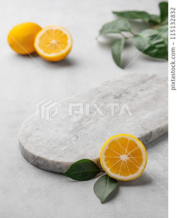 Lemon slices with leaves with marble empty board on gray background. 115132832