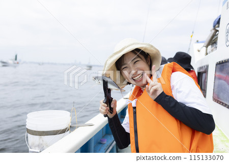 Cute woman enjoying fishing 115133070