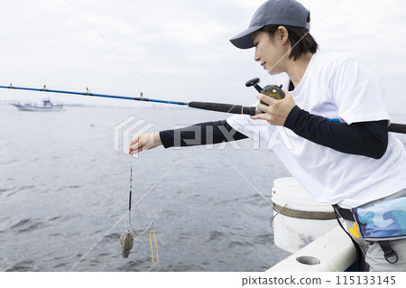 Cute woman enjoying fishing Cute woman enjoying fishing 115133145