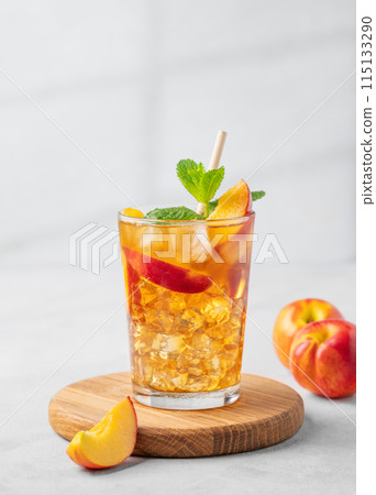 Refreshing peach iced mint tea. The concept of a healthy homemade cold summer drink Refreshing peach iced mint tea. The concept of a healthy homemade cold summer drink 115133290
