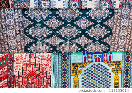 pattern of traditional Asian carpet at oriental bazaar in Tashkent in Uzbekistan in closeup 115135014