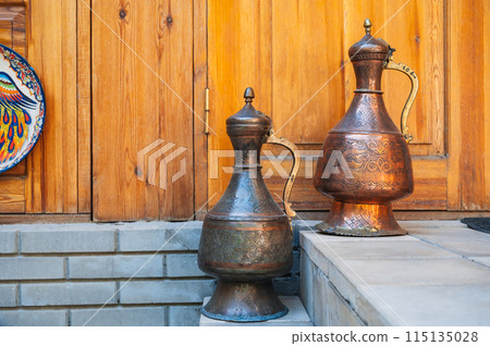 ancient vintage oriental Uzbek copper jugs with East Asian ornaments in Uzbekistan 115135028