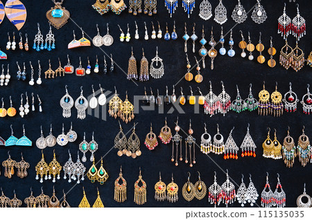 traditional oriental Uzbek earrings in Indian Asian ethnic style on a black background traditional oriental Uzbek earrings in Indian Asian ethnic style on a black background 115135035