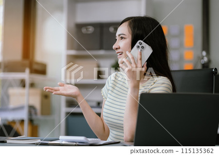 Businesswoman talk mobile phones and working on laptop computers, online business. 115135362