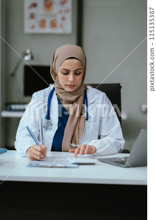 Doctor working in hospital use calculator, Healthcare and medical concept. Doctor working in hospital use calculator, Healthcare and medical concept. 115135387
