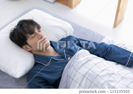 Man sleeping soundly in bed Man sleeping soundly in bed 115135505