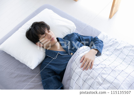 Man sleeping soundly in bed 115135507