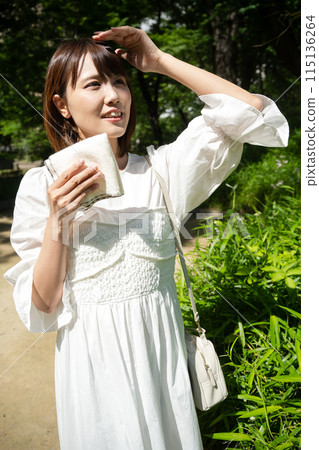 一個女人在陽光明媚的日子戶外散步 115136264