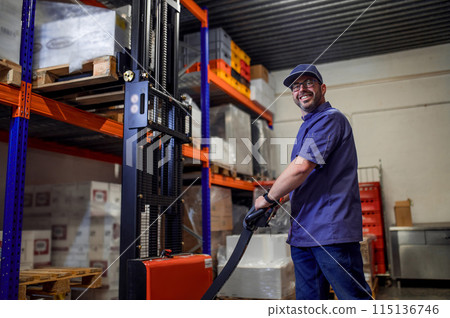 Man in blue uniform standing in warehouse Man in blue uniform standing in warehouse 115136746