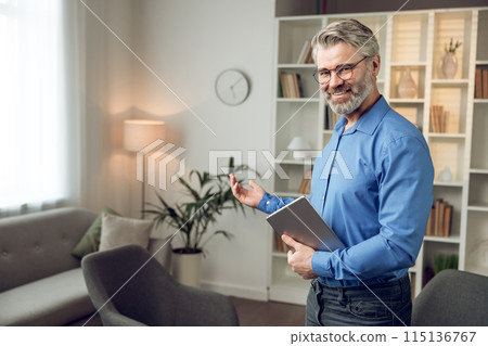 Mental health specialist in shirt standing in his medical clinic office Mental health specialist in shirt standing in his medical clinic office 115136767