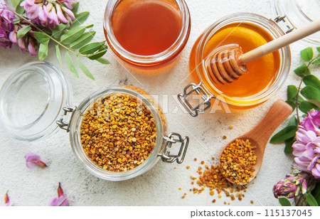Raw organic bee pollen and honey in jars. 115137045