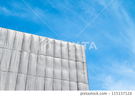 A construction site covered with protective sheets 115137128