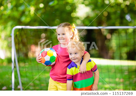 Kids play football. Child at soccer field. 115137269