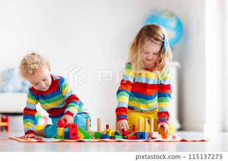 Kids playing with wooden toy train 115137273