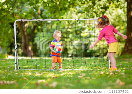Kids play football. Child at soccer field. 115137461