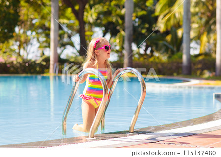 Child in swimming pool with ball. Kids swim. Child in swimming pool with ball. Kids swim. 115137480
