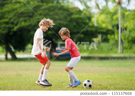 Child playing football. Kids play soccer. Child playing football. Kids play soccer. 115137608
