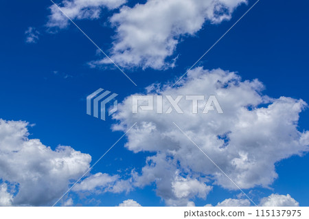 White clouds flowing in the midsummer blue sky White clouds flowing in the midsummer blue sky 115137975