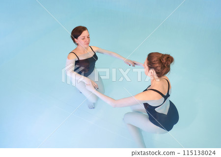 Two woman in pool. Watsu. Water rehabilitation massage. Aqua therapy exercise Two woman in pool. Watsu. Water rehabilitation massage. Aqua therapy exercise 115138024