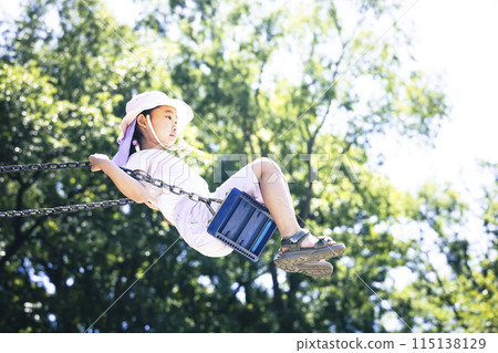 Elementary school student playing with a swing 115138129
