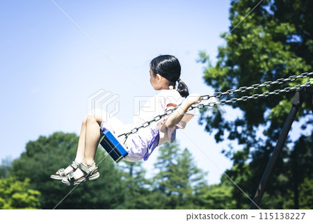 Elementary school student playing with a swing 115138227