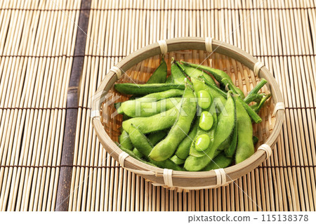 Edamame beans served on a bamboo mat and colander Edamame beans served on a bamboo mat and colander 115138378