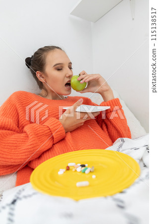 During illness, the teenager decided to eat a green apple full of vitamin C. 115138517