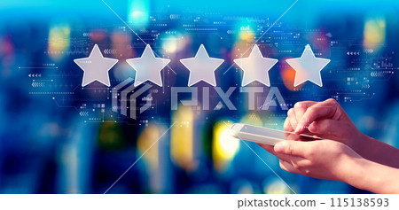 Rating star concept with person using a smartphone at night Rating star concept with person using a smartphone at night 115138593