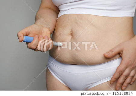 Injection Pen and Female Stomach. Semaglutide or Insulin Injection pen Diabetes Drug Being Used  115138934