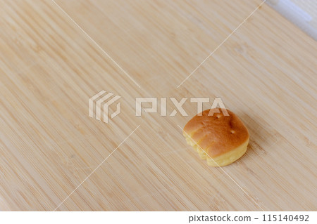 Bread shaped like a baby's hand on a wooden table 115140492