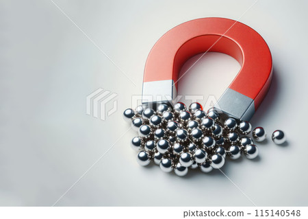 A magnet that attracts metal balls. Space for text. 115140548
