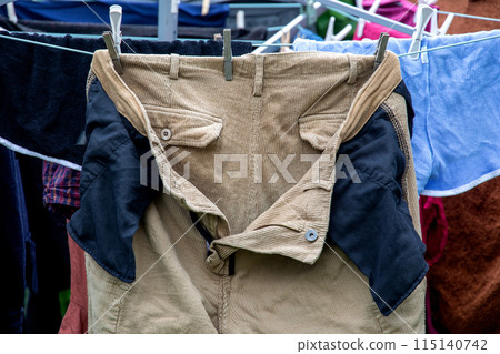 Corduroy Trousers Drying on a Garden Washing Line Corduroy Trousers Drying on a Garden Washing Line 115140742