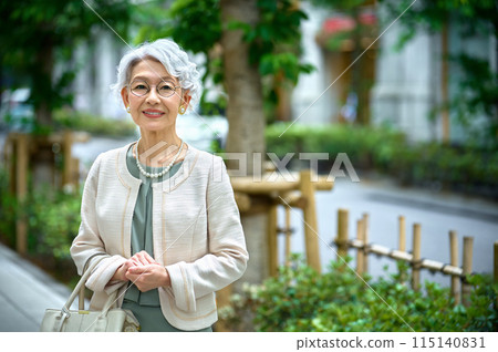 Senior woman with a bag going out 115140831