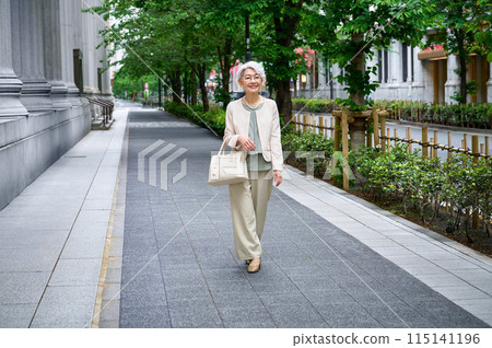 Senior woman with a bag going out Senior woman with a bag going out 115141196