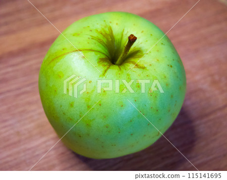 Bright image of a single apple, suggesting simplicity and focus on healthy eating. Bright image of a single apple, suggesting simplicity and focus on healthy eating. 115141695