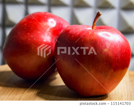 Glossy Red Apples. Shiny apples on wood with a patterned backdrop, ideal for health content. Glossy Red Apples. Shiny apples on wood with a patterned backdrop, ideal for health content. 115141703