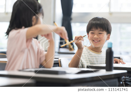 Elementary school girls and boys learning calligraphy in a bright elementary school classroom - Fun image 115141741