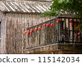 Rustic house with red lanterns, charming balcony, and a mix of traditional and natural design 115142034
