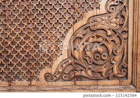 ancient east pattern Uzbek traditional ornament on wooden carved door in Tashkent in Uzbekistan ancient east pattern Uzbek traditional ornament on wooden carved door in Tashkent in Uzbekistan 115142564