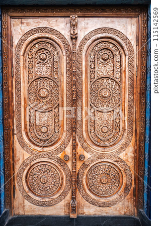 ancient Islamic pattern Uzbek traditional ornament on wooden carved door in Museum of Political Repression in Uzbekistan 115142569