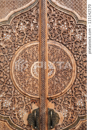 oriental asian pattern Uzbek ornament on wooden carved door in Museum of Political Repression in Tashkent in Uzbekistan close-up 115142570