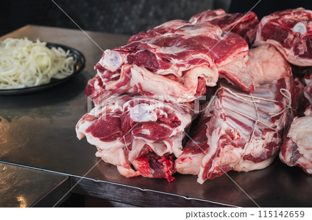 Fresh raw lamb meat on counter for cooking traditional Asian Uzbek pilaf in restaurant Besh Qozon in Tashkent in Uzbekistan 115142659