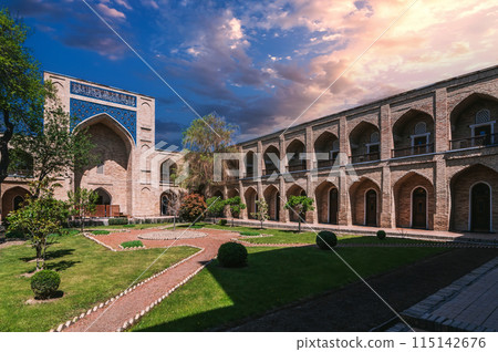 courtyard of ancient Uzbek Kukeldash Madrasah in Tashkent in Uzbekistan. Old medieval Islamic madrassah under beautiful sky in summer 115142676