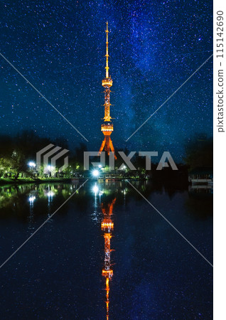 asian landmark illuminated TV tower at night in Tashkent in Uzbekistan with a reflection in water of river on background of a blue night sky with stars asian landmark illuminated TV tower at night in Tashkent in Uzbekistan with a reflection in water of river on background of a blue night sky with stars 115142690