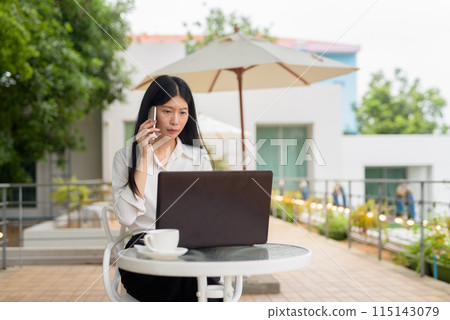 Young woman working on laptop at outdoor terrace cafe with coffee, business concept 115143079