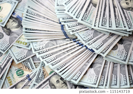 Very big amount of US hundred dollar bills close up. Huge quantity of united states currency notes on flat table Very big amount of US hundred dollar bills close up. Huge quantity of united states currency notes on flat table 115143719