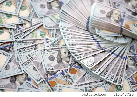 Very big amount of US hundred dollar bills close up. Huge quantity of united states currency notes on flat table 115143726