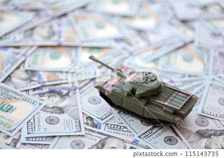 Toy tank on US hundred dollar bills banknotes close up. The concept of war costs, military spending and economic crisis 115143735