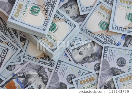 Very big amount of US hundred dollar bills close up. Huge quantity of united states currency notes on flat table 115143739